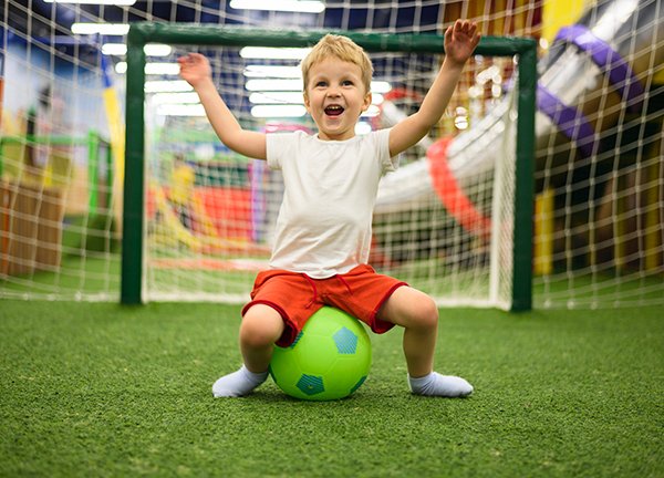 excited boy sitting ball
